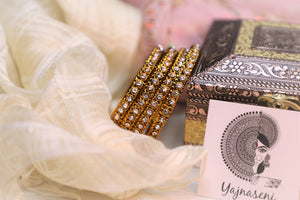 Gold bangles with White stones