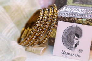 Gold bangles with White stones